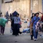 Palestinians with their belongings flee to safer areas in Gaza City after Israeli air strikes, on October 13, 2023. Israel has called for the immediate relocation of 1.1 million people in Gaza amid its massive bombardment in retaliation for Hamas's attacks, with the United Nations warning of "devastating" consequences. (Photo by MAHMUD HAMS / AFP)